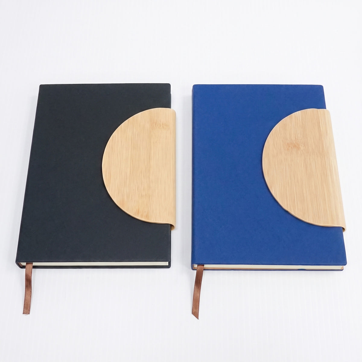 Custom laser-engraved A5 leatherette notebooks with bamboo half-moon flap by Print365 Kenya