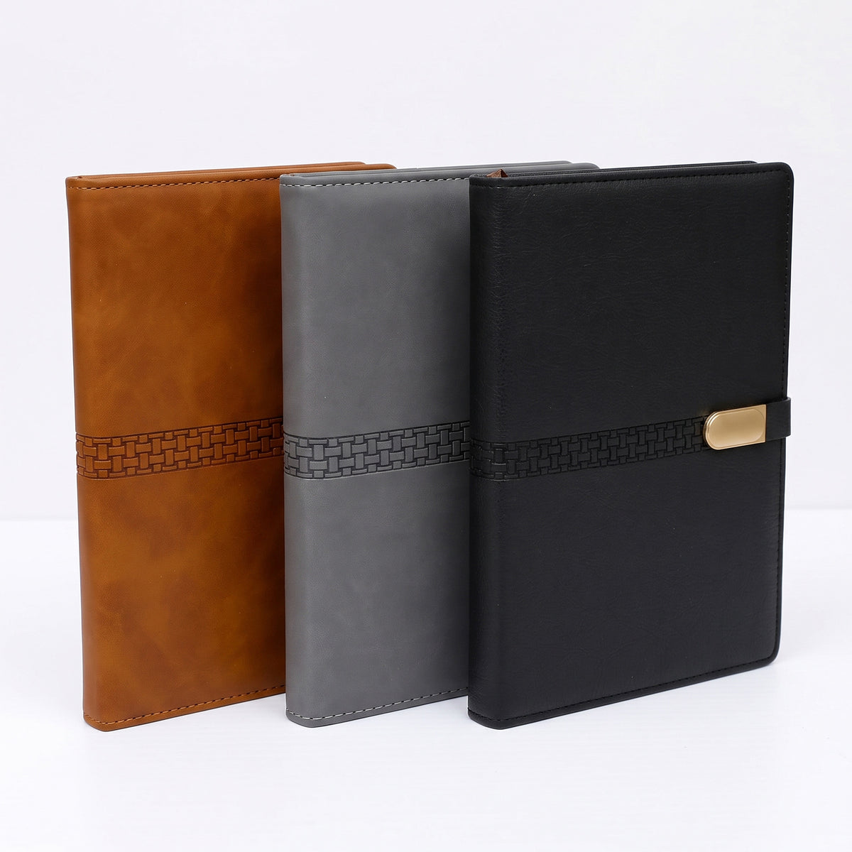 Custom debossed executive B5 leatherette notebooks with woven pattern band by Print365 Kenya