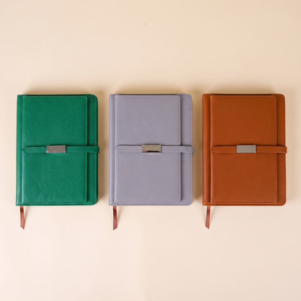 Custom debossed executive A5 leatherette notebooks with metal clasp straps by Print365 Kenya