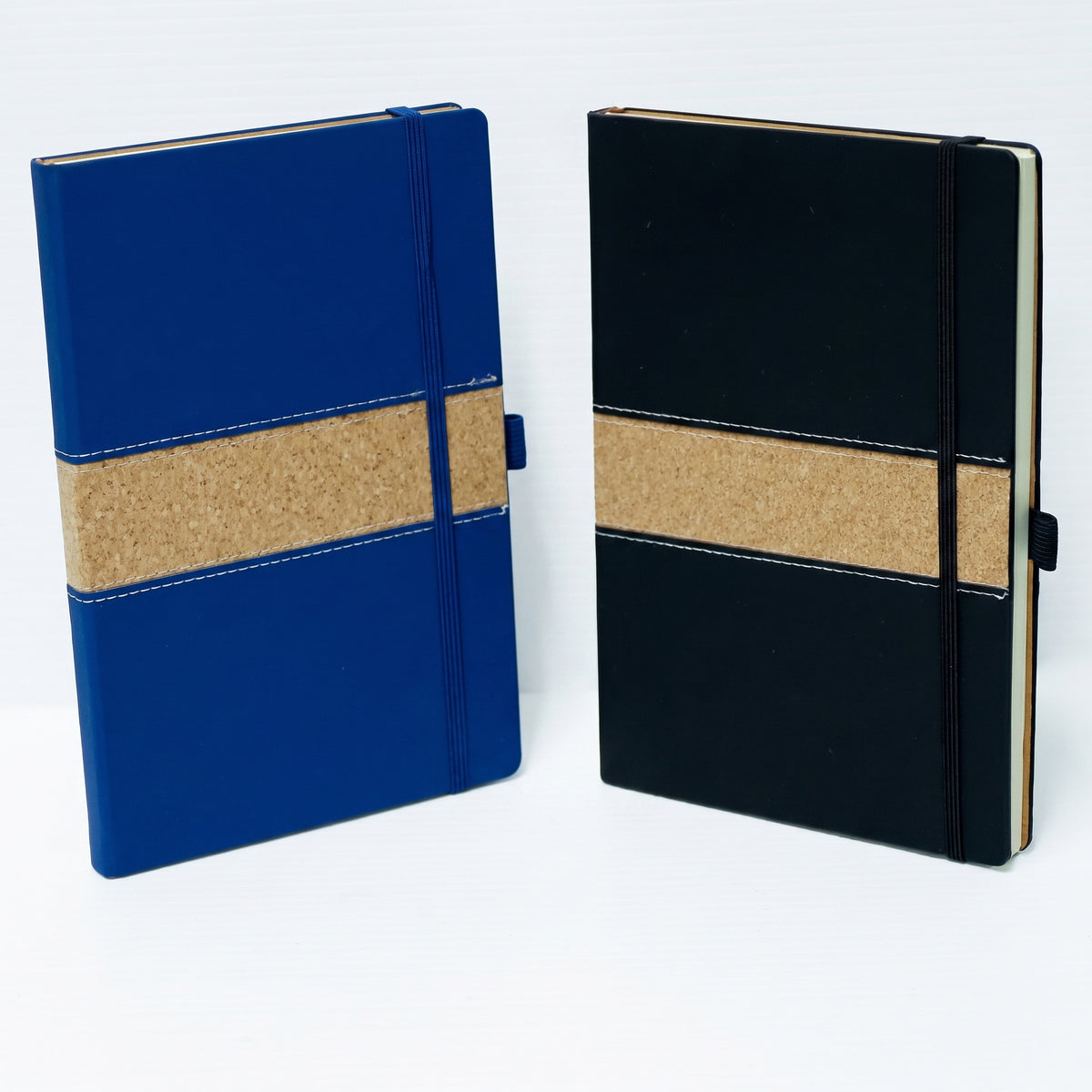 Custom debossed A5 leatherette notebooks with natural cork accent bands by Print365 Kenya