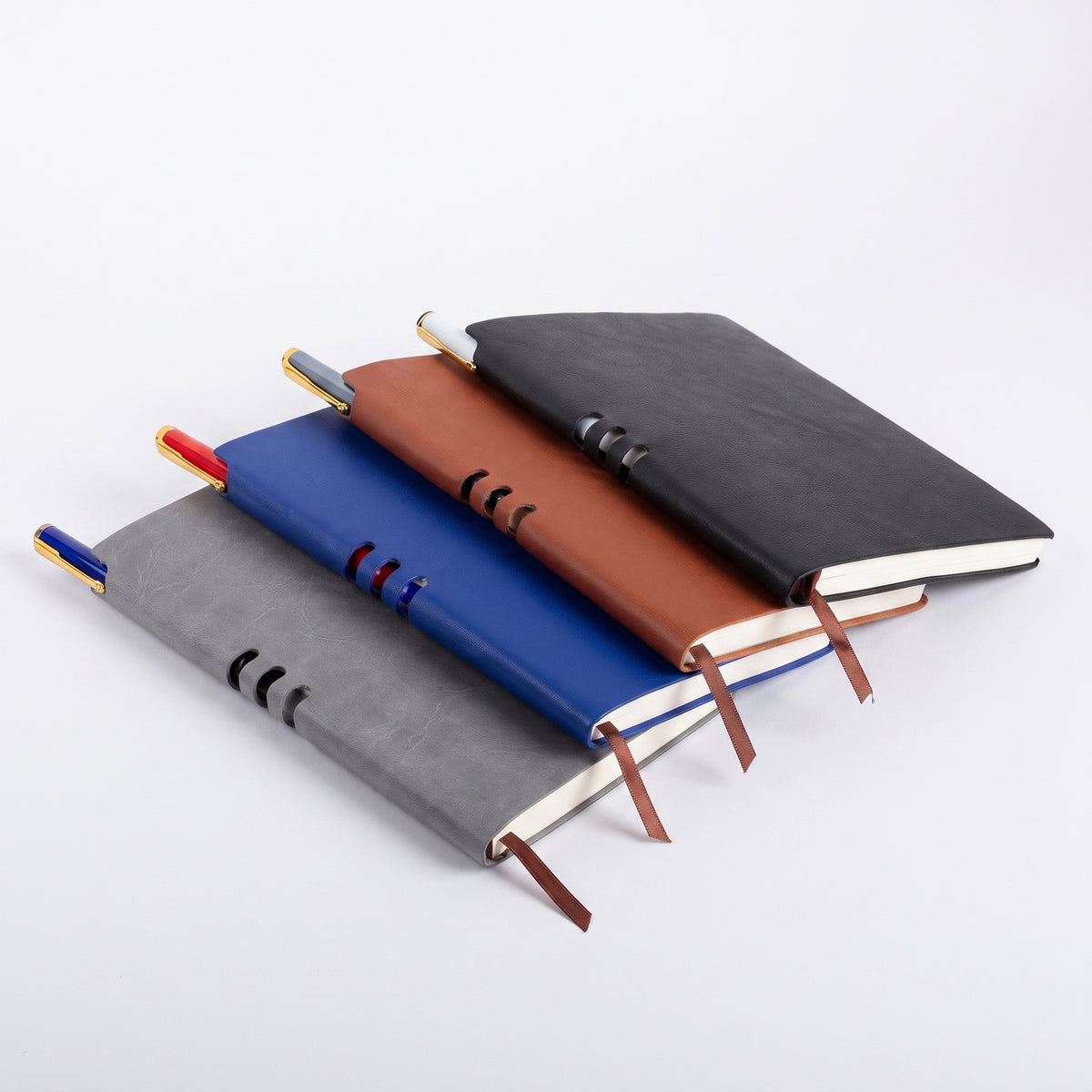 Custom debossed A5 leatherette notebooks with spine pen holder slots by Print365 Kenya