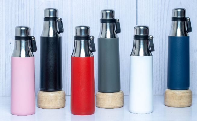 Display of custom powder-coated Arrow steel thermal flasks in black white red blue grey and pink by Print365 Kenya