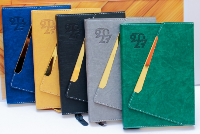 Display of custom executive 2027 leatherette diaries in blue wooden black grey green by Print365 Kenya