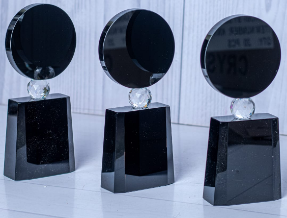 Custom laser-engraved black crystal circular award trophy with clear sphere collar by Print365 Kenya