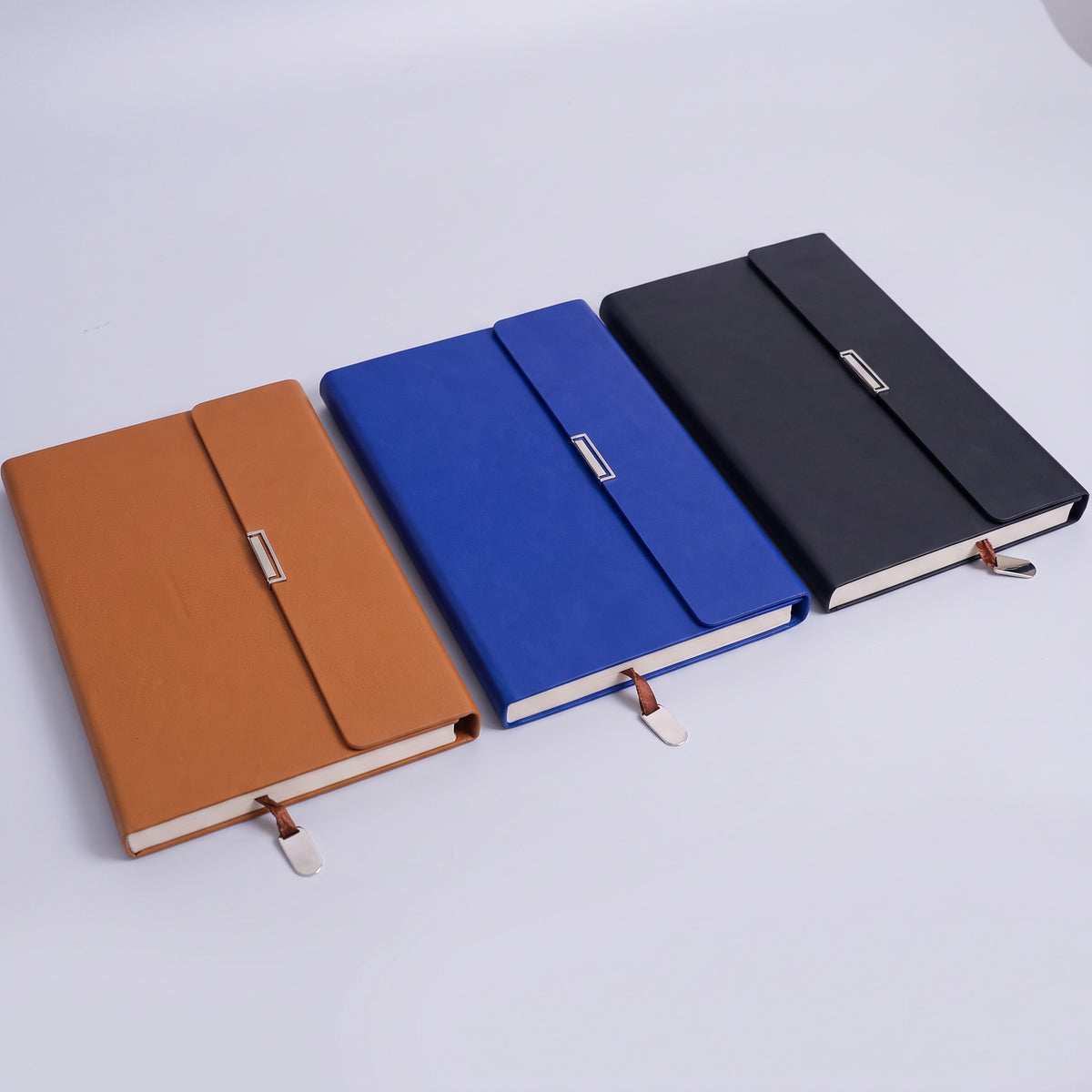 Custom debossed executive B5 leatherette notebooks with metal clasp flap by Print365 Kenya