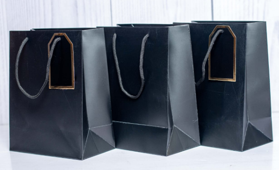 Custom printed executive black A4 paper gift bag with gold rimmed gift tag by Print365 Kenya