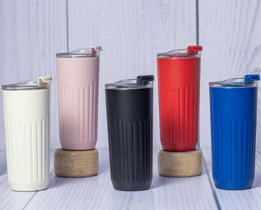 Display of custom powder-coated stainless steel thermal mugs in cream white pink black red and blue by Print365 Kenya