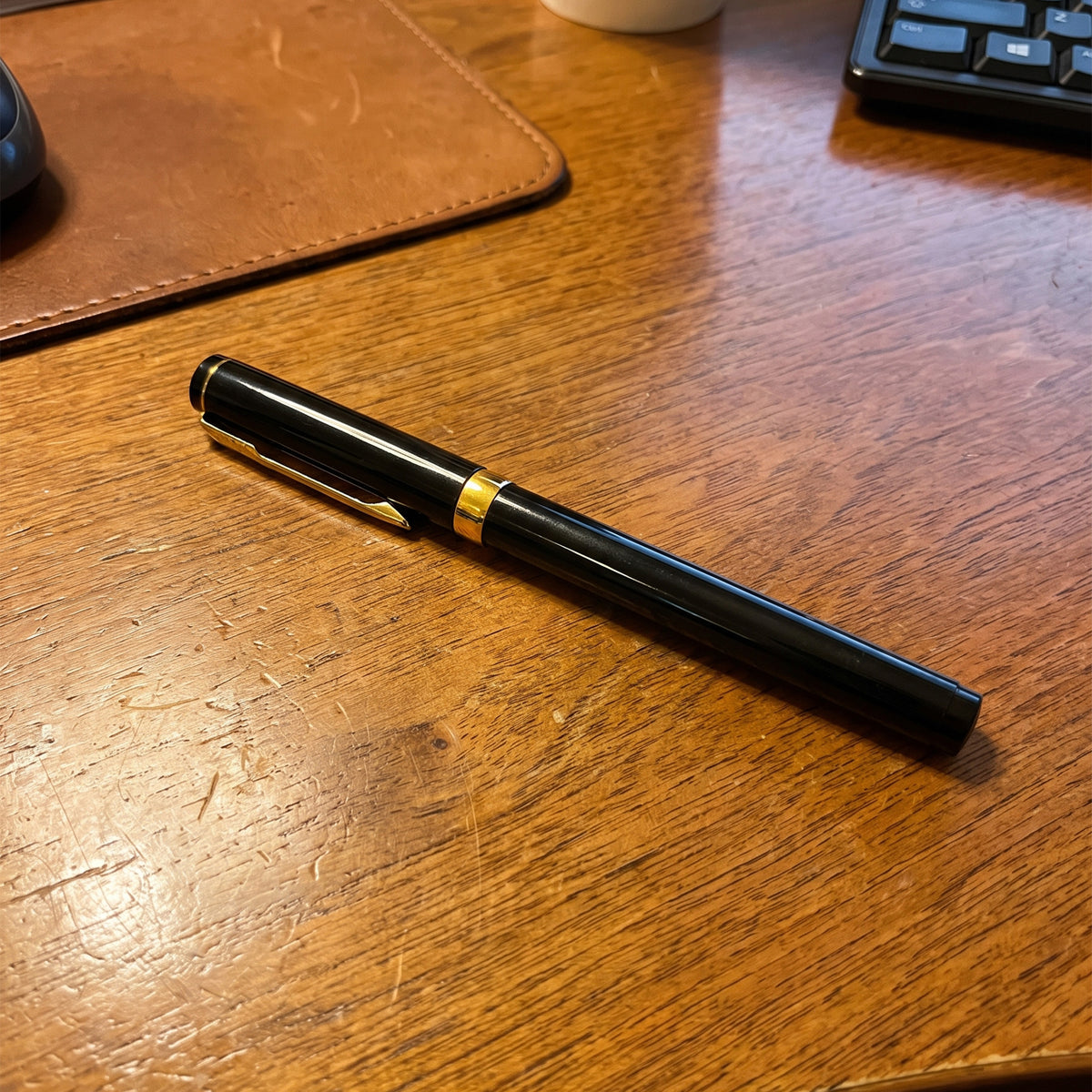 Custom laser-engraved luxury black metal executive pen with gold trim accents by Print365 Kenya