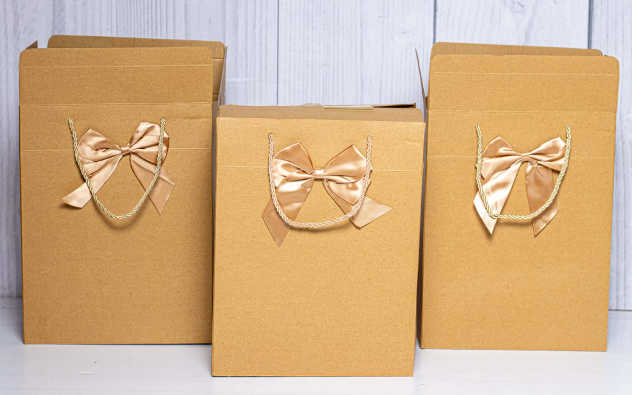 Custom branded classy gold kraft portrait gift bag with satin bow by Print365 Kenya