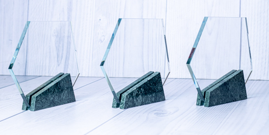 Custom laser-engraved hexagonal crystal award trophy with dark green marble base by Print365 Kenya