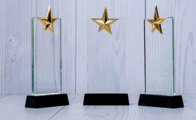 Custom laser-engraved rectangular crystal award trophy with top gold star accent by Print365 Kenya