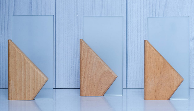 Custom laser-engraved rectangular glass award with diagonal natural wood wedge base by Print365 Kenya