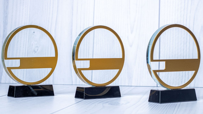 Custom laser-engraved circular crystal award trophy with gold ring border by Print365 Kenya