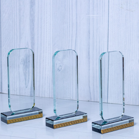 Custom laser-engraved rectangular crystal award trophy with gold pattern base by Print365 Kenya