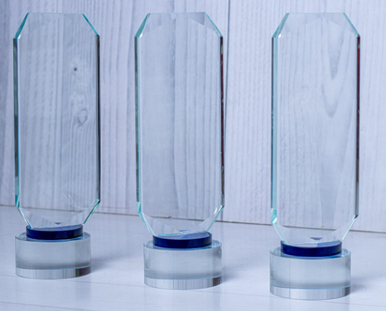 Custom laser-engraved tall column crystal award trophy with blue crystal collar by Print365 Kenya
