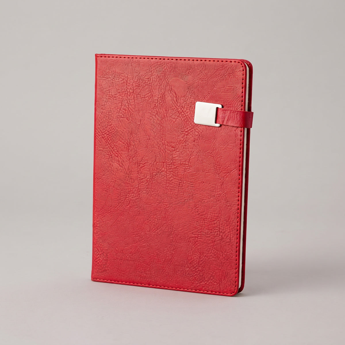 Custom branded A5 textured leatherette notebook with metal buckle magnetic strap by Print365 Kenya
