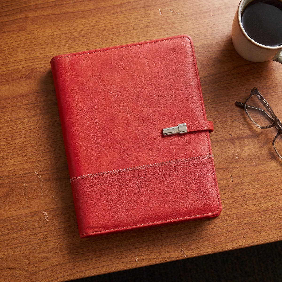 Custom debossed executive A5 crimson red leatherette notebook with zigzag stitching by Print365 Kenya