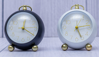 Custom laser-printed matte black and white desk clocks with gold ring handles by Print365 Kenya