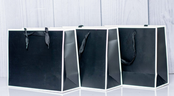 Custom printed luxury black extra-large landscape paper gift bag with white border piping by Print365 Kenya