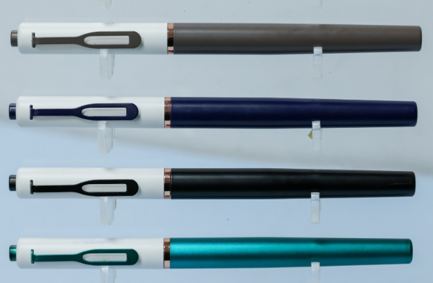 Custom laser-engraved dual-tone white upper metal pens with copper accent ring by Print365 Kenya