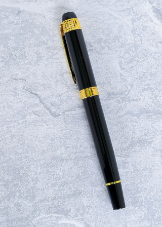 Custom laser-engraved executive glossy black metal pen with textured gold cap band by Print365 Kenya
