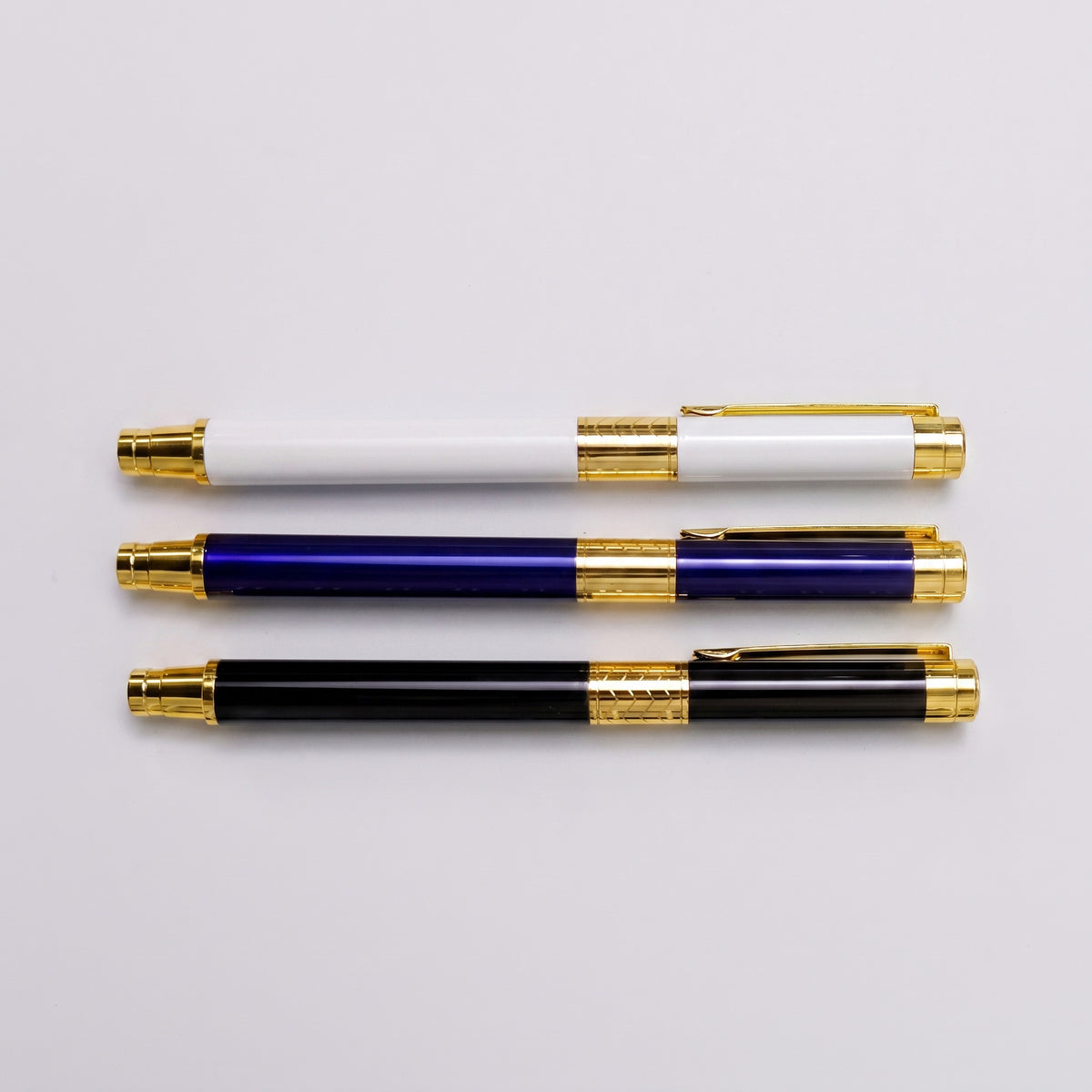 Custom laser-engraved executive metal pens with intricate gold band trim by Print365 Kenya