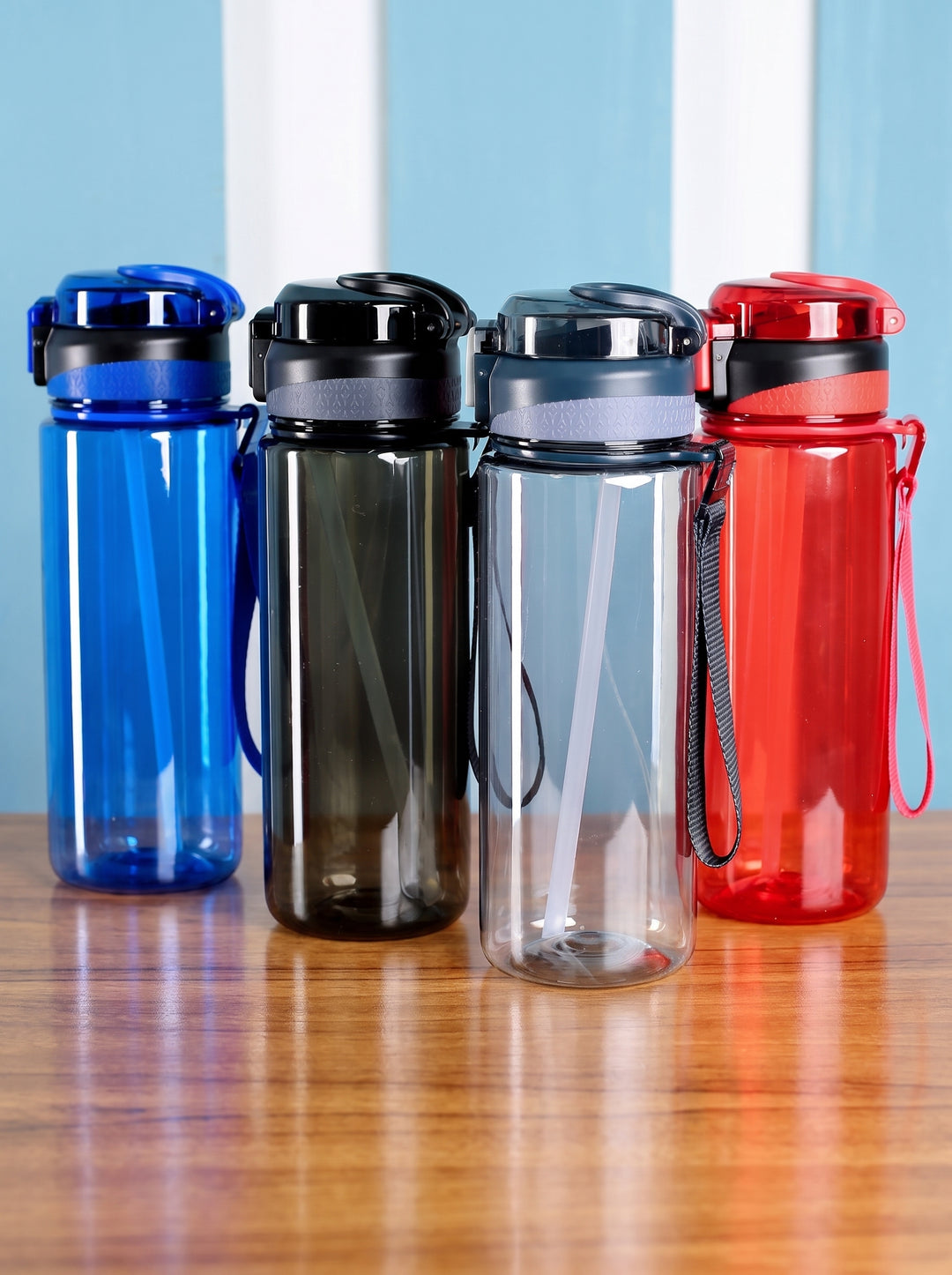 Lineup of 800ml translucent plastic water bottles with internal straws in blue, black, grey, and red by Print365 Kenya