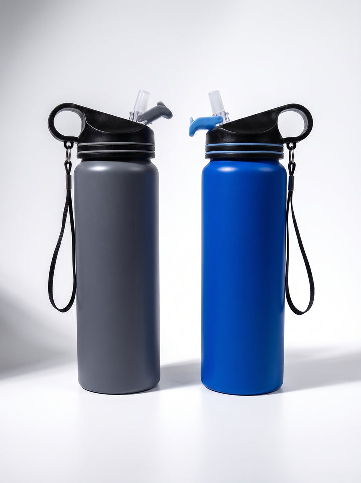 Two matte insulated water bottles in dark gray and blue with black lids and strap done in Nairobi, Kenya