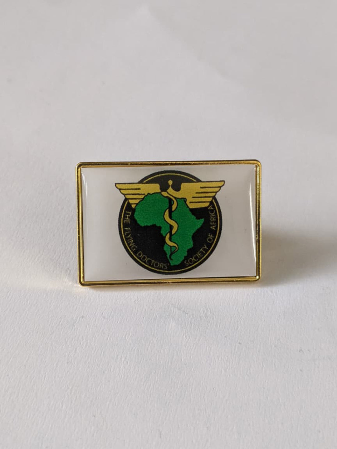 Custom laser-printed rectangular metallic lapel pin 3cm by 2.25cm with gold trim by Print365 Kenya