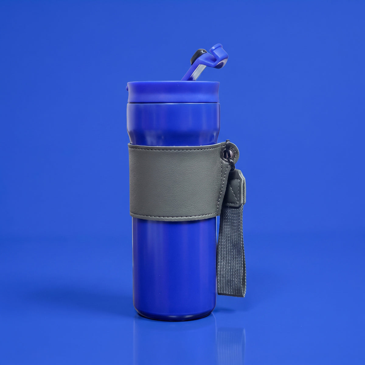 Custom laser-engraved royal blue thermal mug with stitched grey leather sleeve by Print365 Kenya