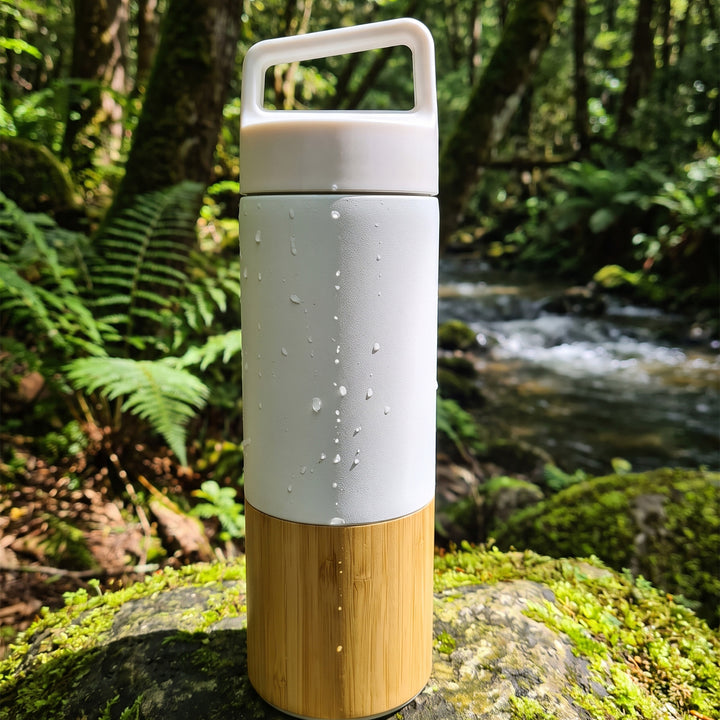 Custom laser-engraved 600ml white thermal flask with natural wooden base accent by Print365 Kenya
