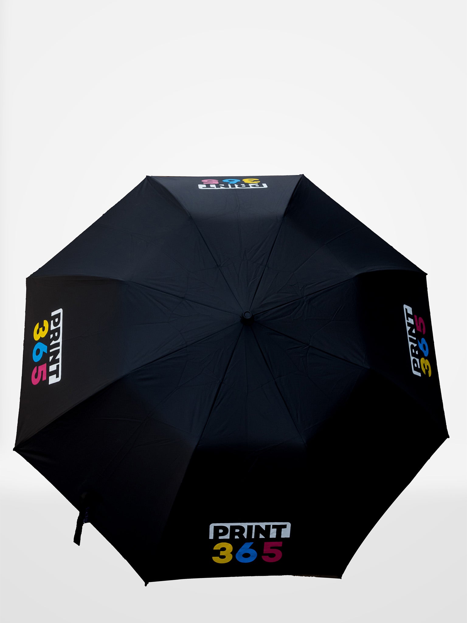 Black umbrella with 'Print 365' branding on a white background