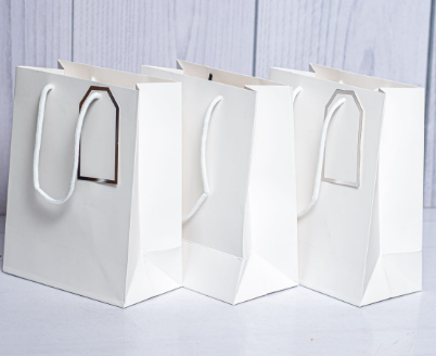 Custom printed executive white A5 paper gift bag with silver rimmed gift tag by Print365 Kenya