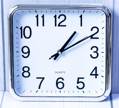 Custom laser-printed metallic silver square wall clock with rounded corners by Print365 Kenya