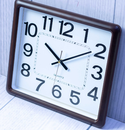 Custom laser-printed dark mahogany square wall clock with rounded corners by Print365 Kenya