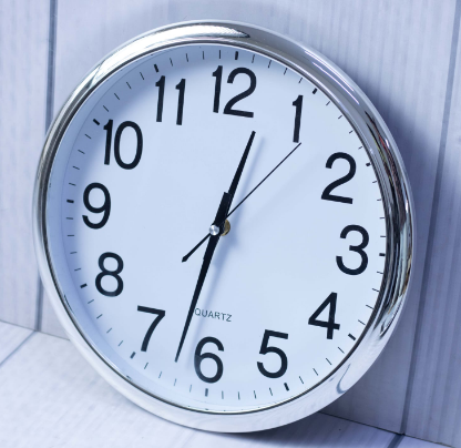 Custom laser-printed round metallic silver wall clock with white dial by Print365 Kenya