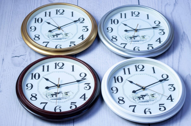 Custom laser-printed executive round wall clock in gold, silver, brown, and white frames by Print365 Kenya