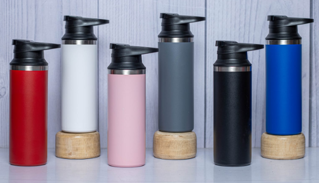 Display of powder-coated stainless steel thermal flasks with flip spout lids by Print365 Kenya