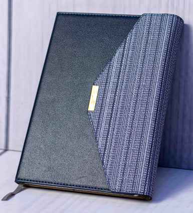 Custom laser-engraved executive A5 curved canvas and leatherette notebook with gold badge by Print365 Kenya
