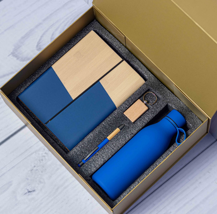 Custom laser-engraved eco bamboo 4-in-1 corporate gift set in blue with gold box by Print365 Kenya