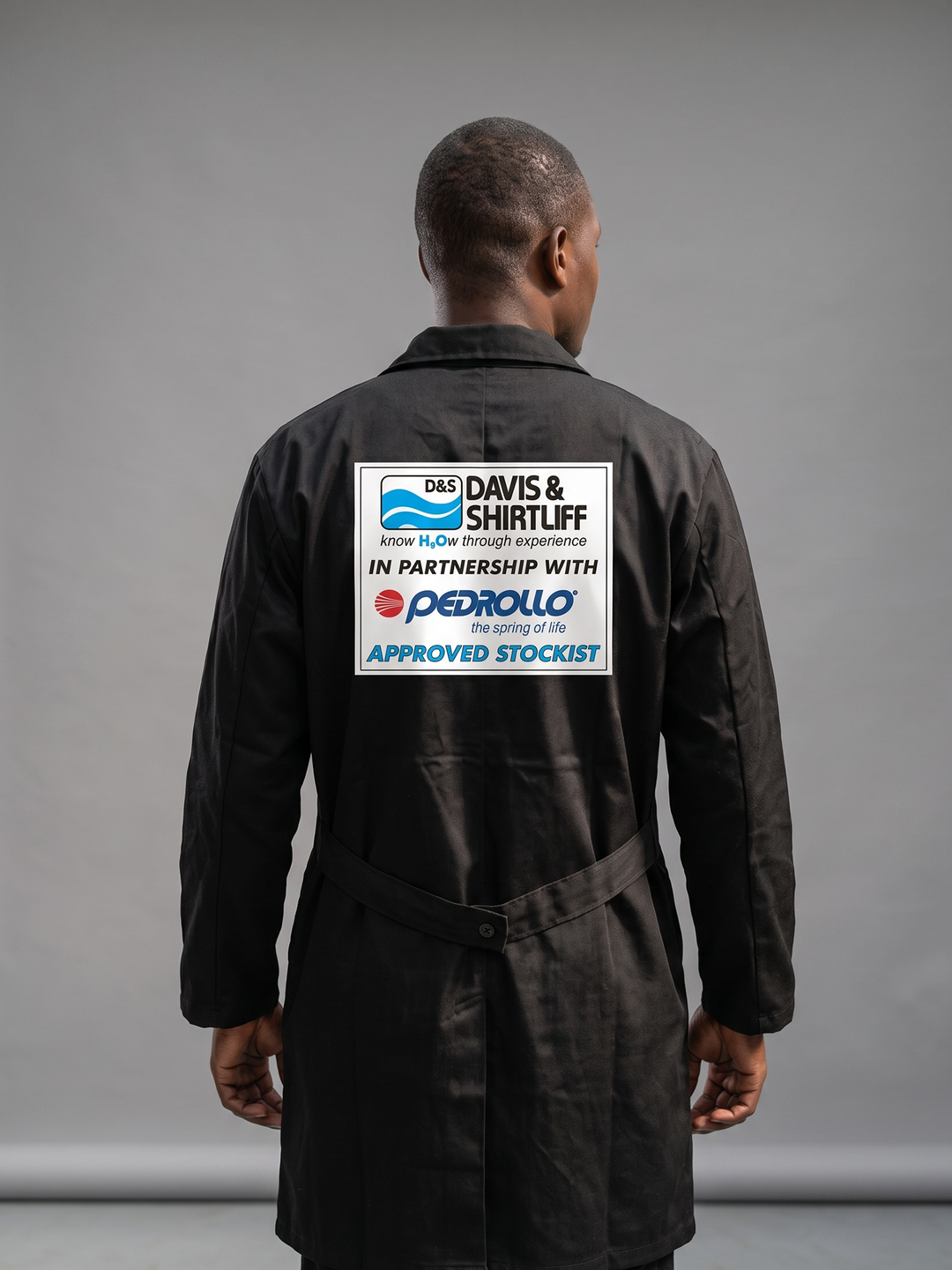 Industrial technician wearing a custom branded dust coat with reflective tape in Nairobi