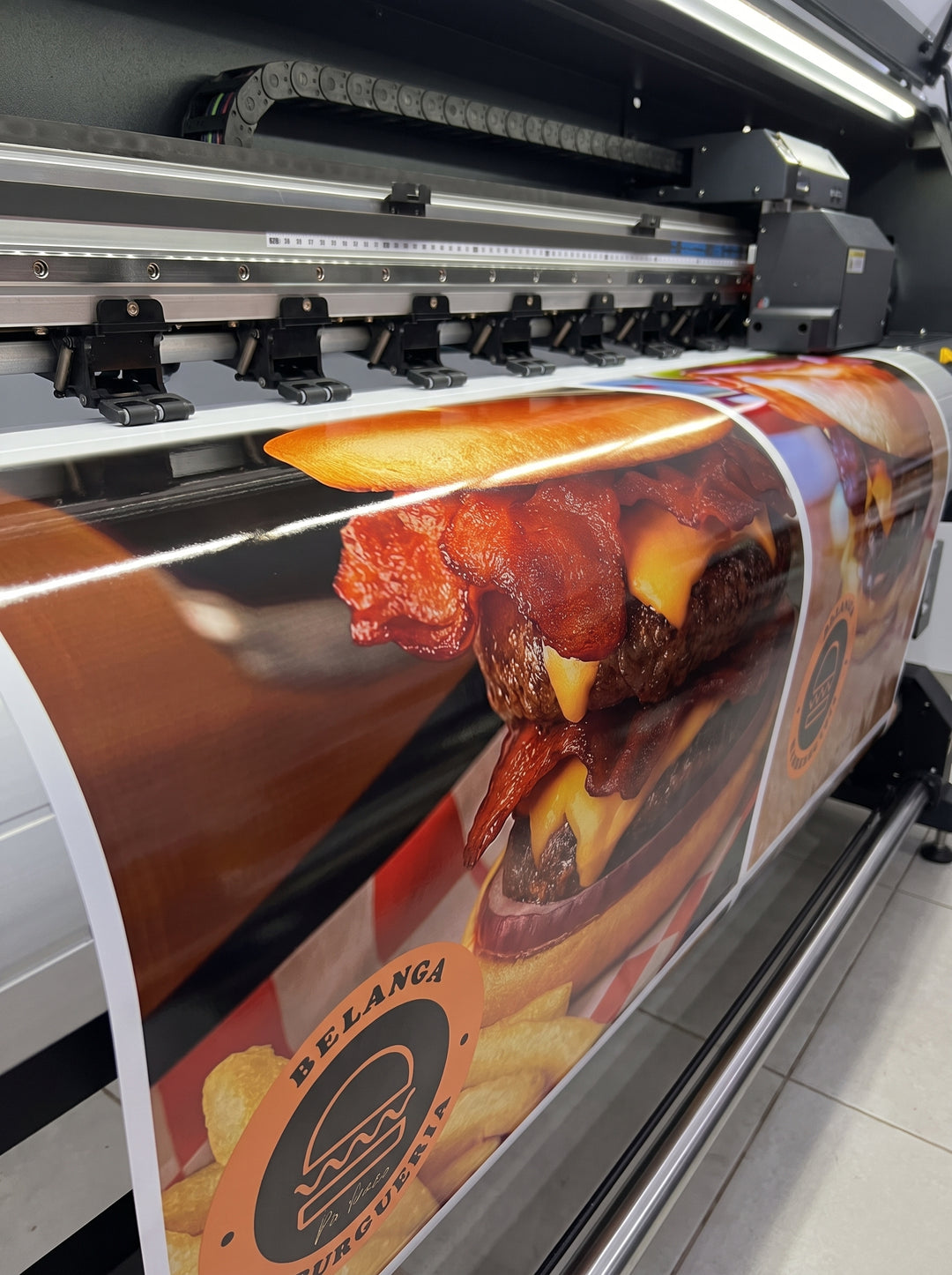 Large format eco-solvent printer printing a full-color outdoor vinyl banner in Nairobi