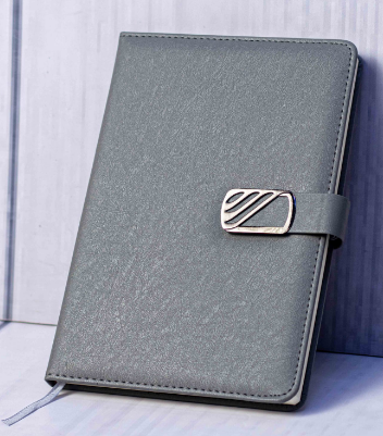 Custom laser-engraved executive A5 grey metallic shimmer notebook with wave emblem strap by Print365 Kenya