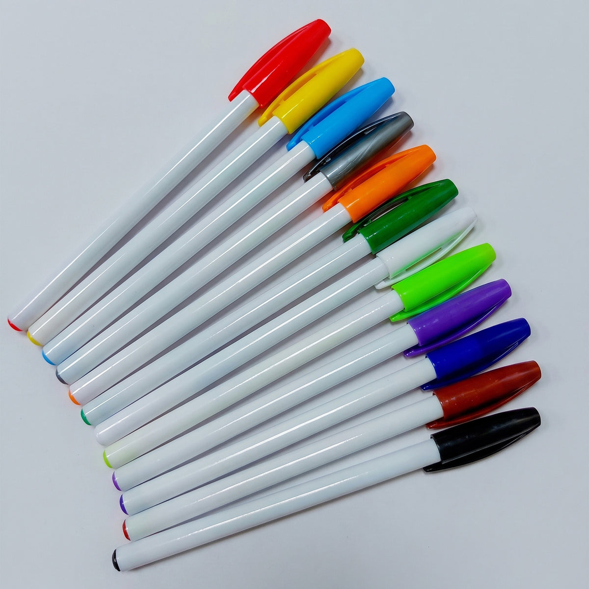 Custom printed white promotional plastic stick pens with colorful caps by Print365 Kenya