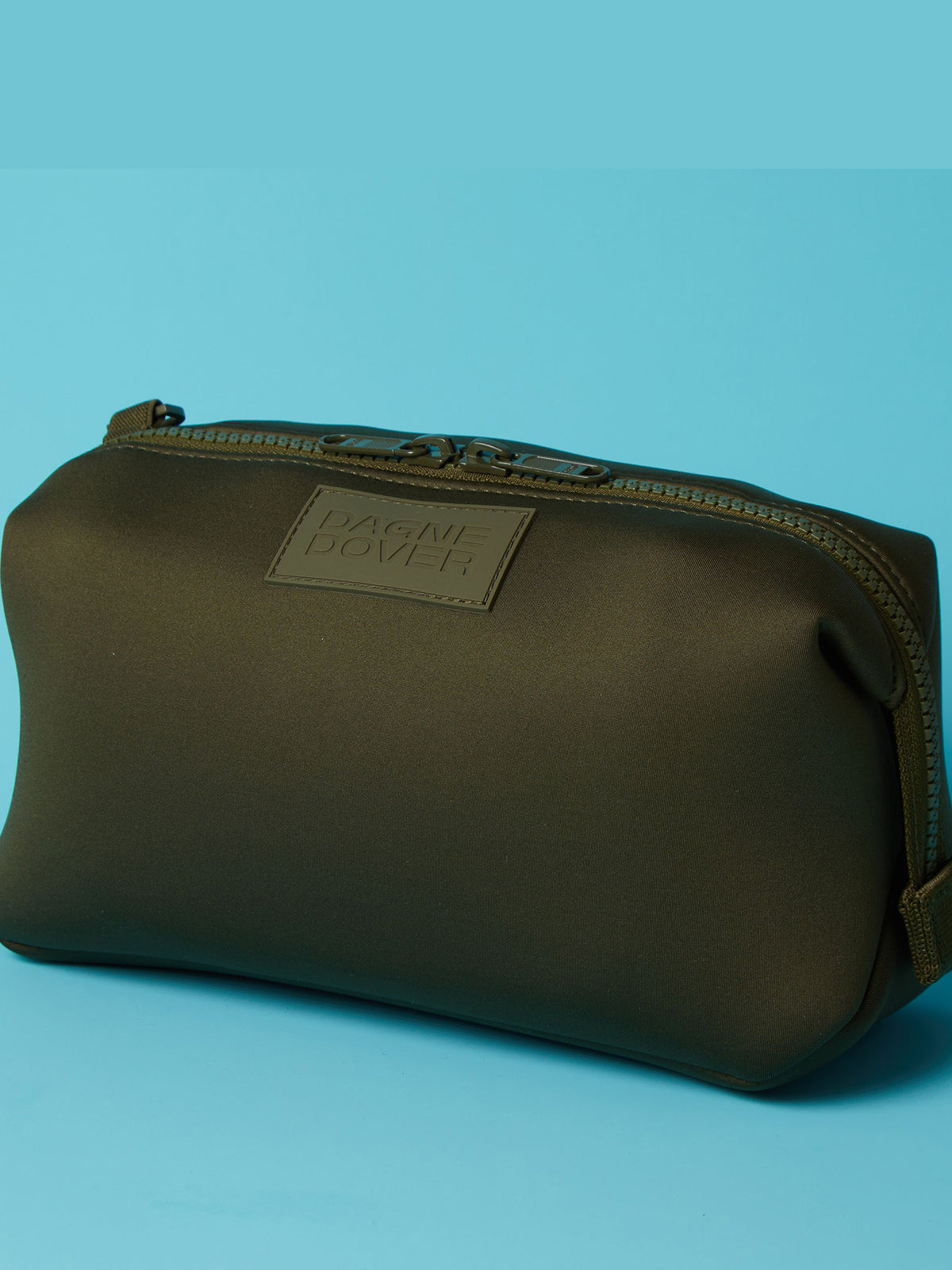 Close-up of high-density logo embroidery on a custom cosmetics travel pouch