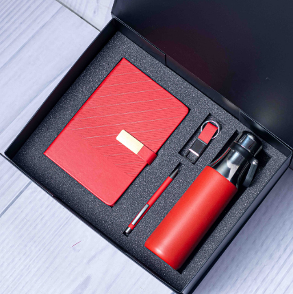 Custom laser-engraved executive 4-in-1 corporate gift set in red with cross-hatch textured notebook by Print365 Kenya