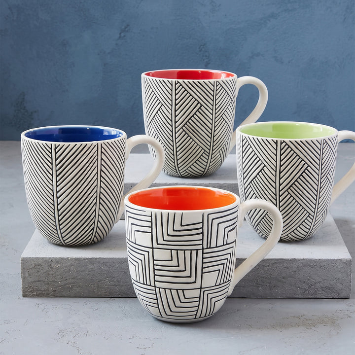 Side-by-side view of red, blue, orange and green customized two-toned concave ceramic coffee mugs in Nairobi Kenya
