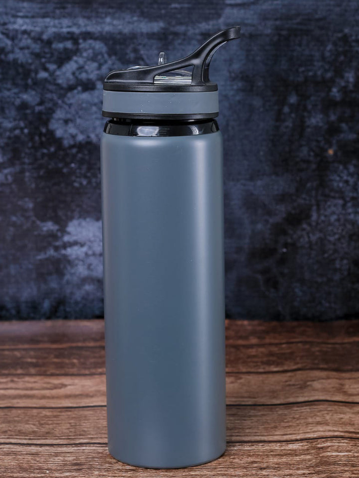 A custom metal matte slate blue water bottle with a black flip-top lid done in Nairobi Kenya